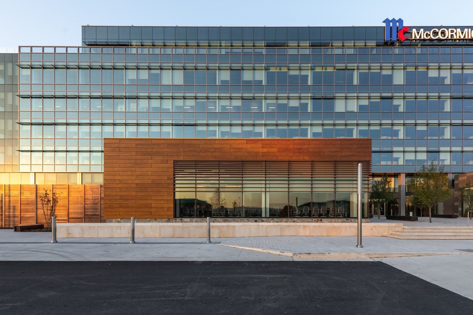McCormick: Wood-clad wing in front of the glass tower at sunset