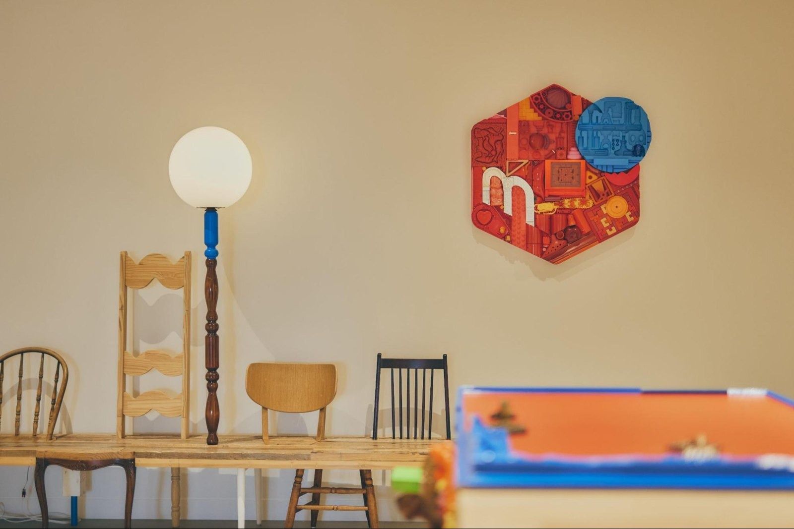 Mercari: Assorted chairs and a lamp in front of a wall with a Mercari emblem