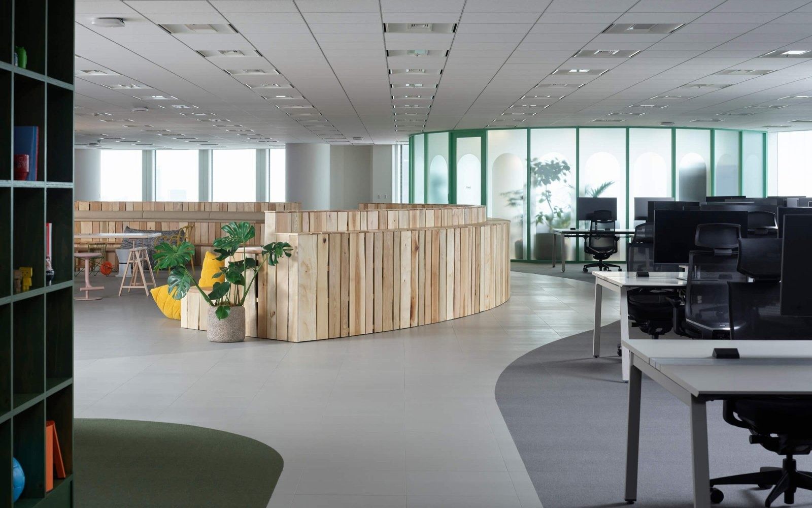 Mercari: Bright open floor with a curved timber-clad block and desks