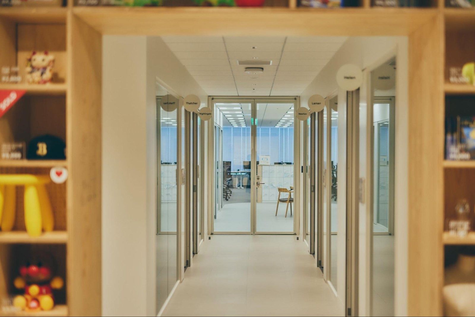 Mercari: Timber-framed doorway leading to a glass corridor