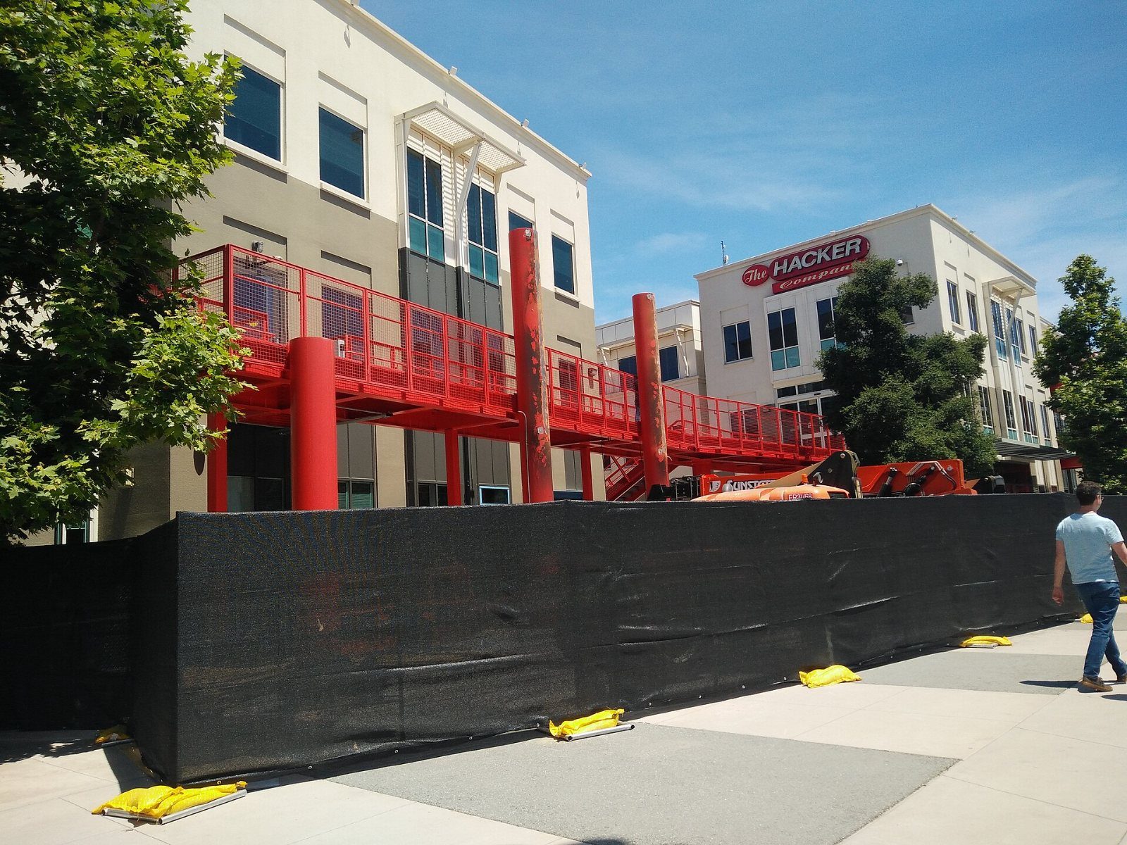 Meta: Red walkway on a building with a Hacker sign
