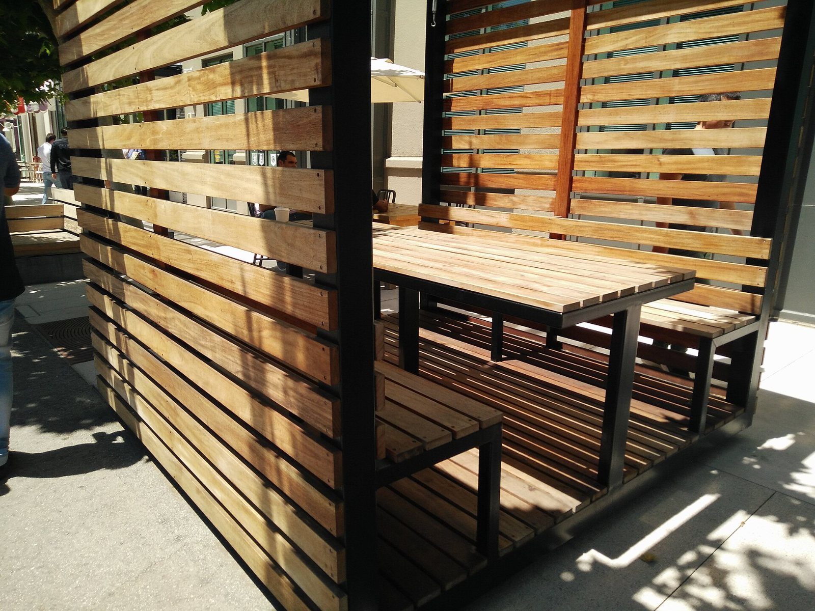 Meta: Wooden slatted booth with a table
