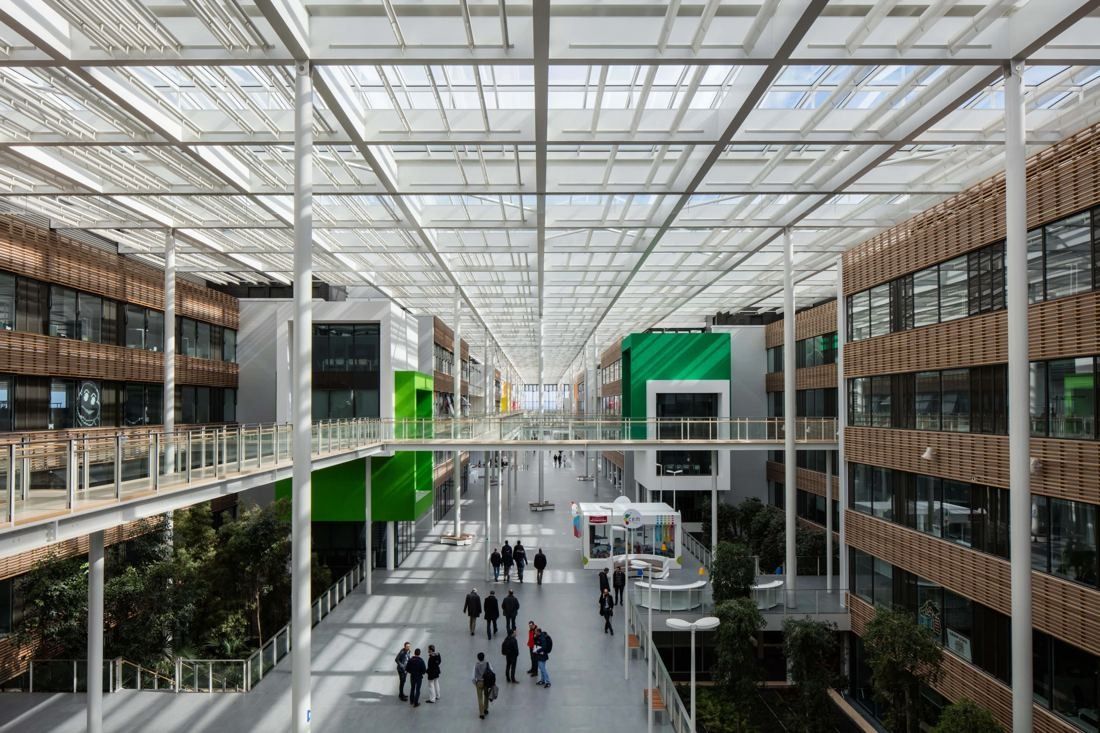 Michelin: Long covered indoor street with glazed roof, walkways and coloured volumes