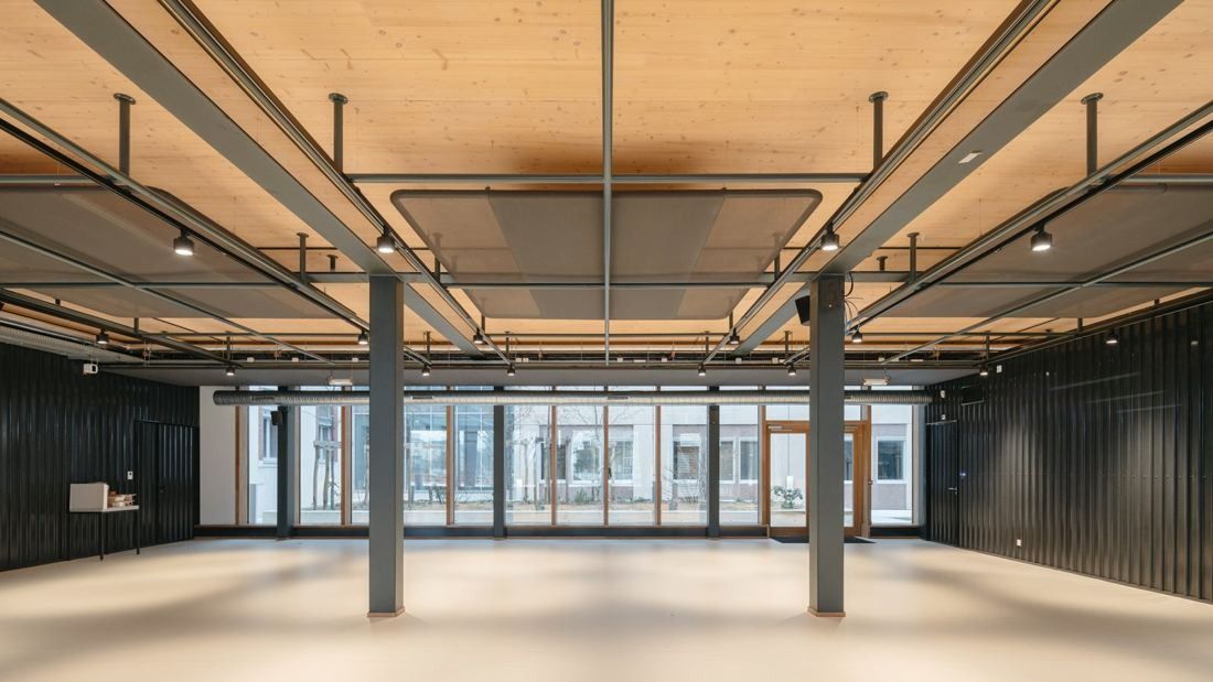 Michelin: Open floor with timber ceiling, exposed ducts and grey columns, empty and ready to fit out