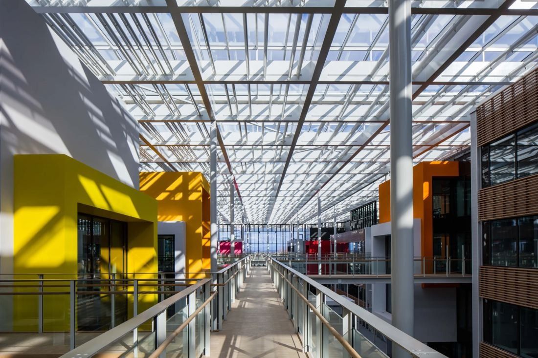 Michelin: Walkway under a glass roof between yellow and orange volumes
