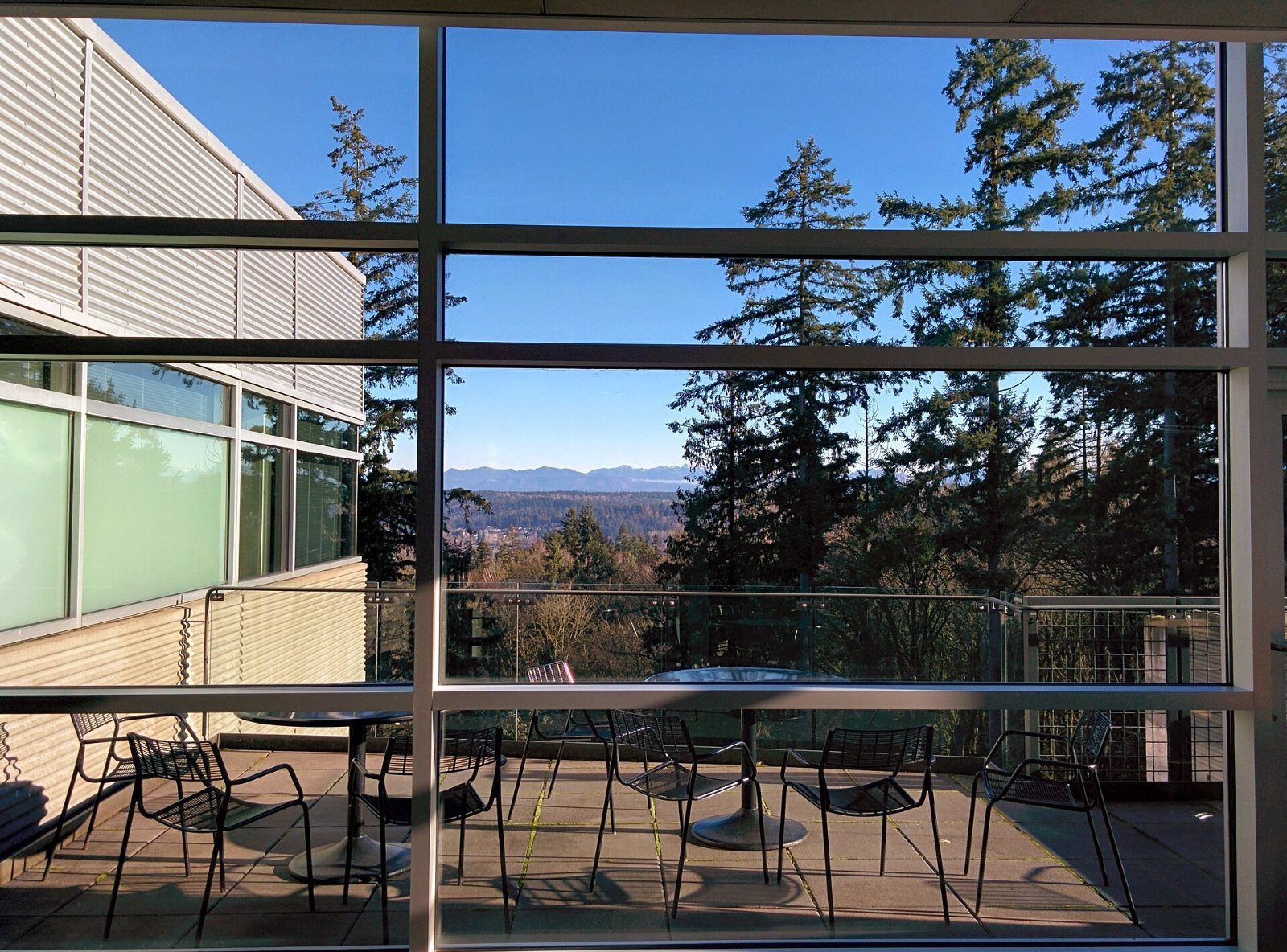 Terrace with tables looking out to trees and mountains