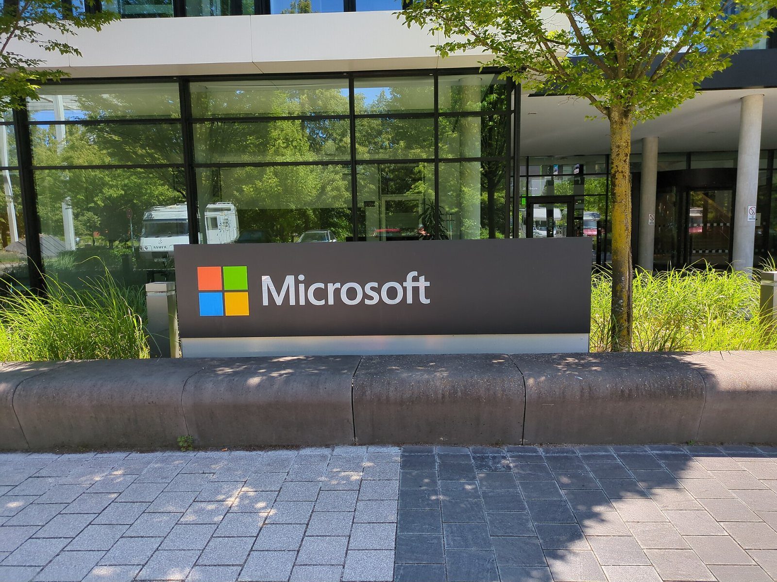Microsoft sign in front of a glass entrance