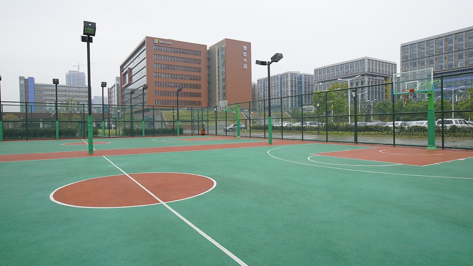 Outdoor basketball court beside office buildings