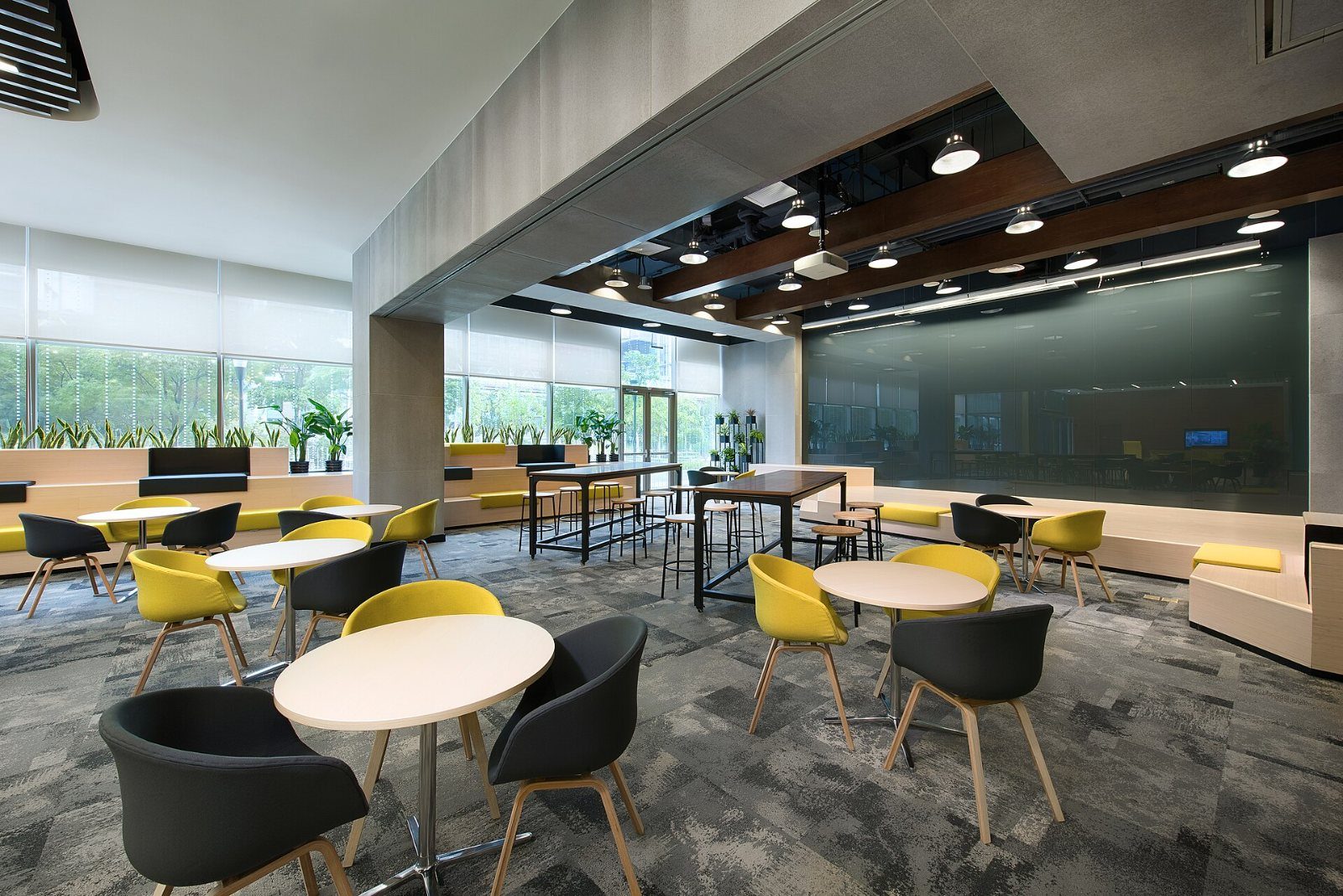 Lounge with round tables and yellow chairs