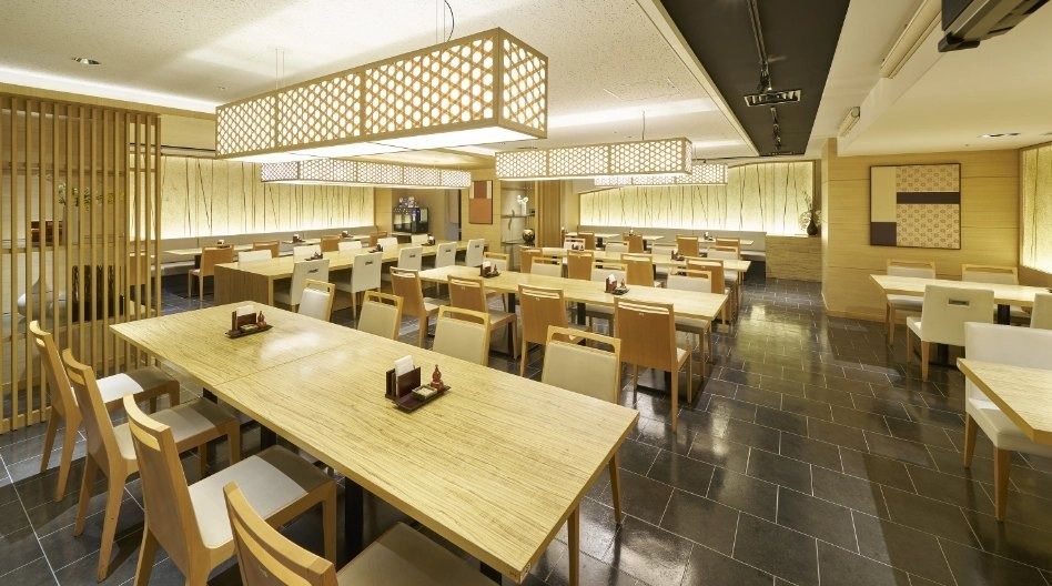 Mitsubishi Corporation: Cafeteria with wooden tables under latticed lights