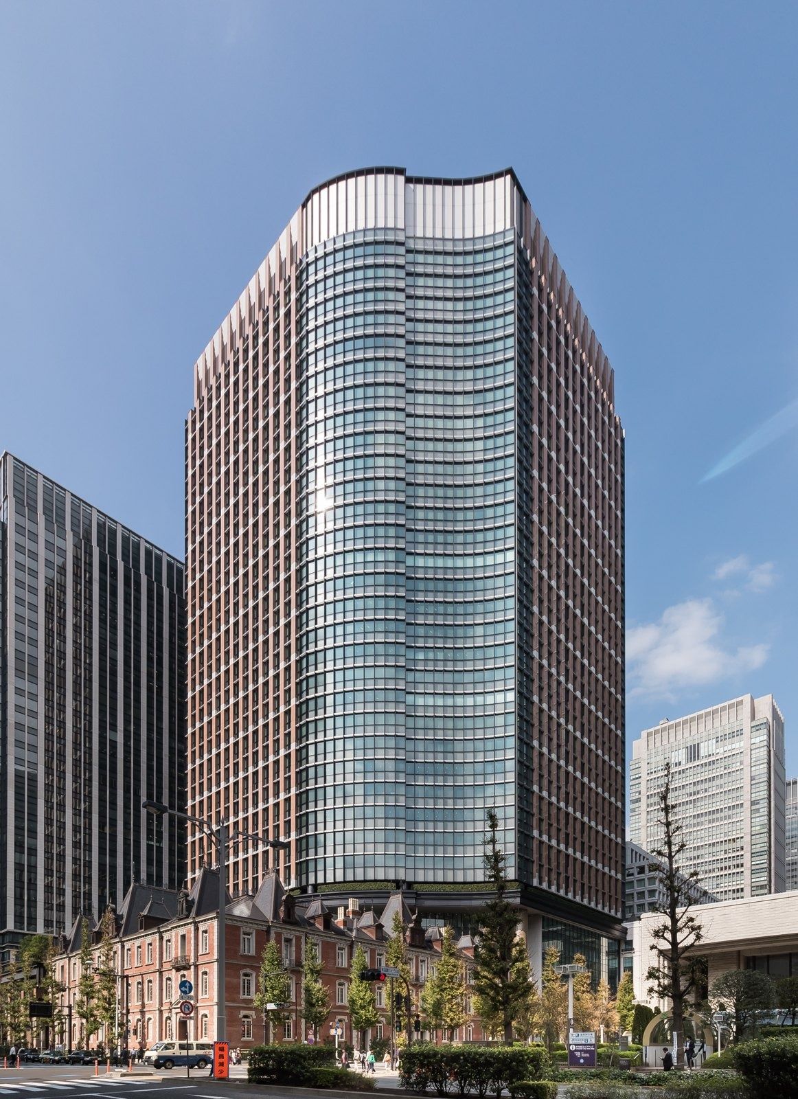 Mitsubishi Corporation: Glass tower rising behind a red-brick low building