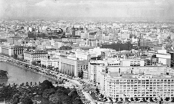 Black-and-white aerial view of office blocks beside a moat
