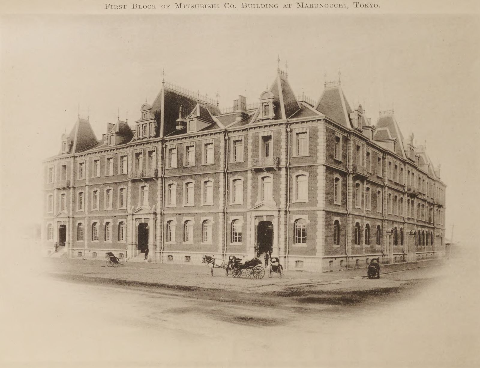 Old photograph of a three-storey red-brick building on a corner
