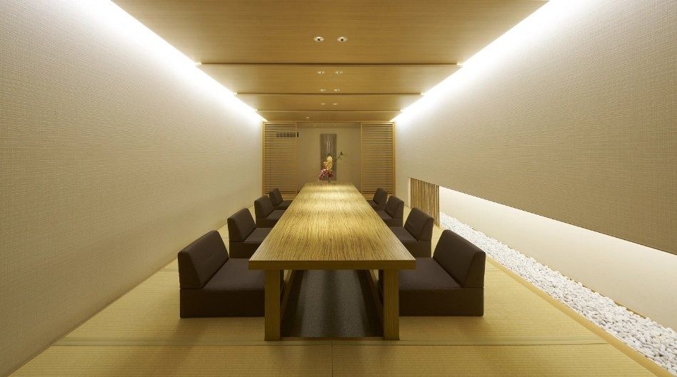 Mitsubishi Corporation: Private dining room with a long table and stone garden strip