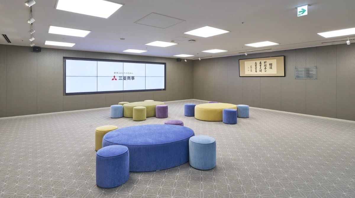 Mitsubishi Corporation: Room with colourful stools and a large screen