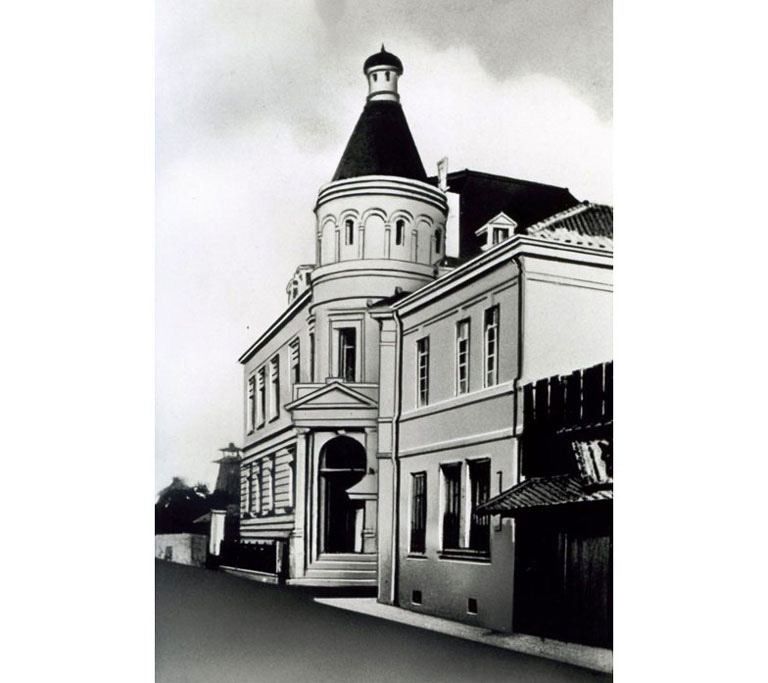 Black-and-white view of a two-storey Western-style building with a domed corner tower