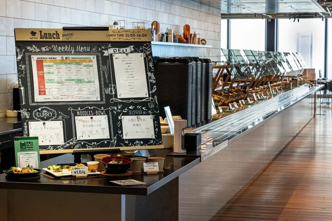 MIXI: Cafeteria counter with a chalkboard menu and dishes on display