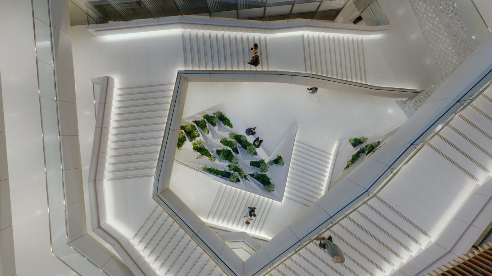 Moderna: Looking down a white stair wrapping around planters