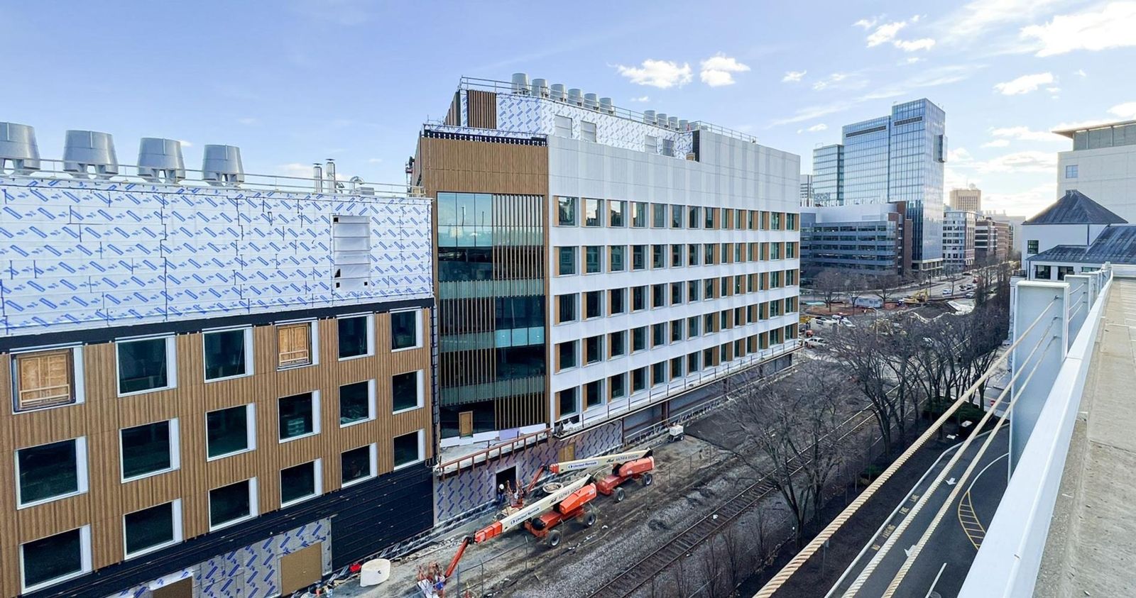 Moderna: The building seen along the railway with Kendall Square behind