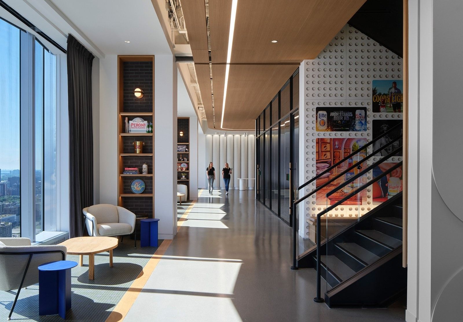 Molson Coors: A bright corridor with shelves of beer memorabilia and a black stair