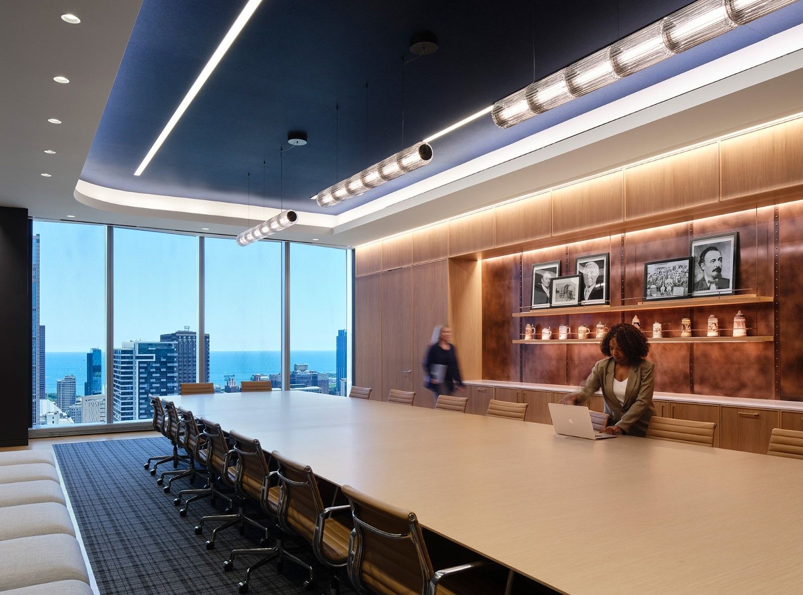 Molson Coors: A long boardroom table with leather chairs and a wall of framed bottles, with a city view