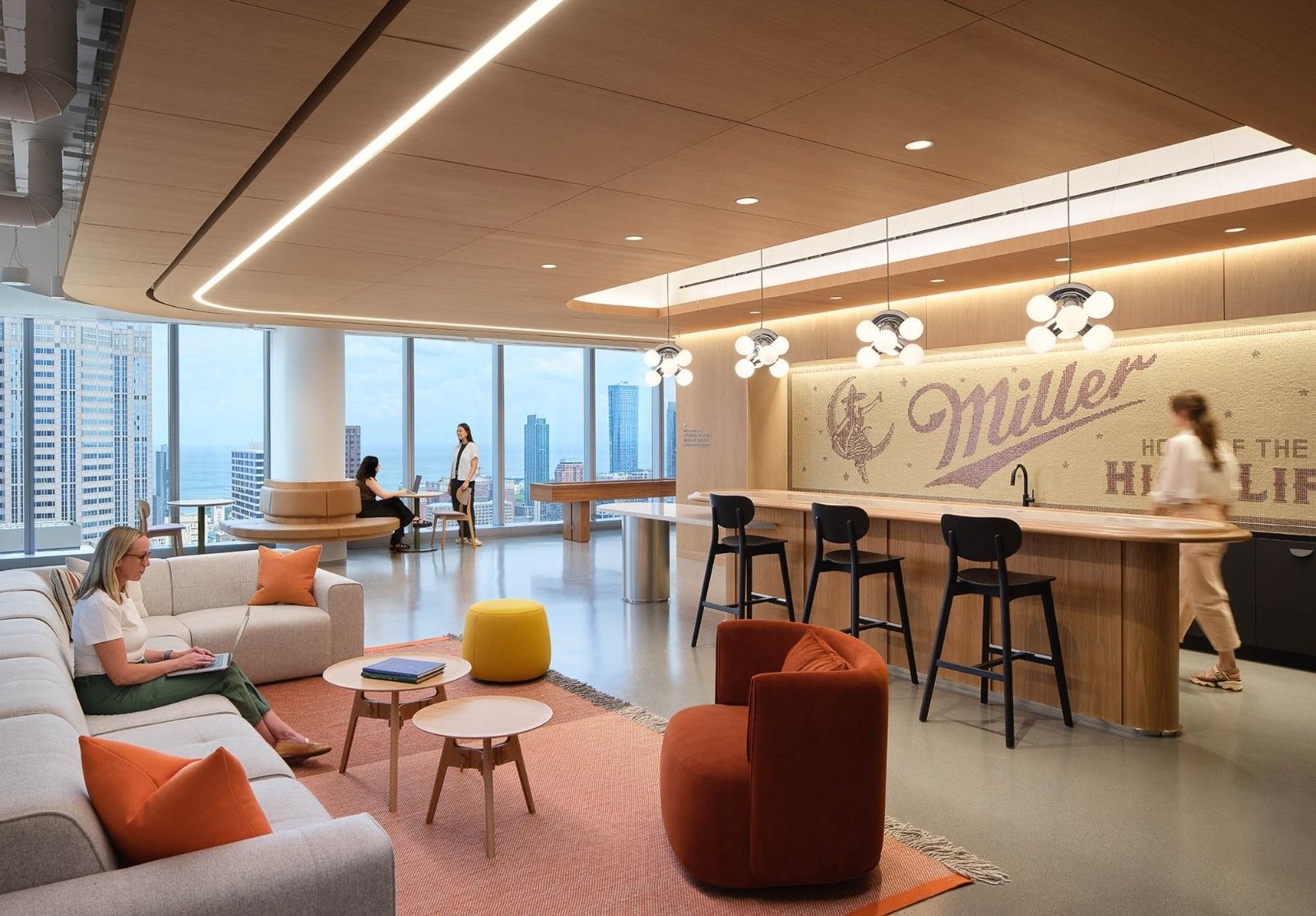 Molson Coors: A lounge with orange armchairs and a bar with a Miller logo