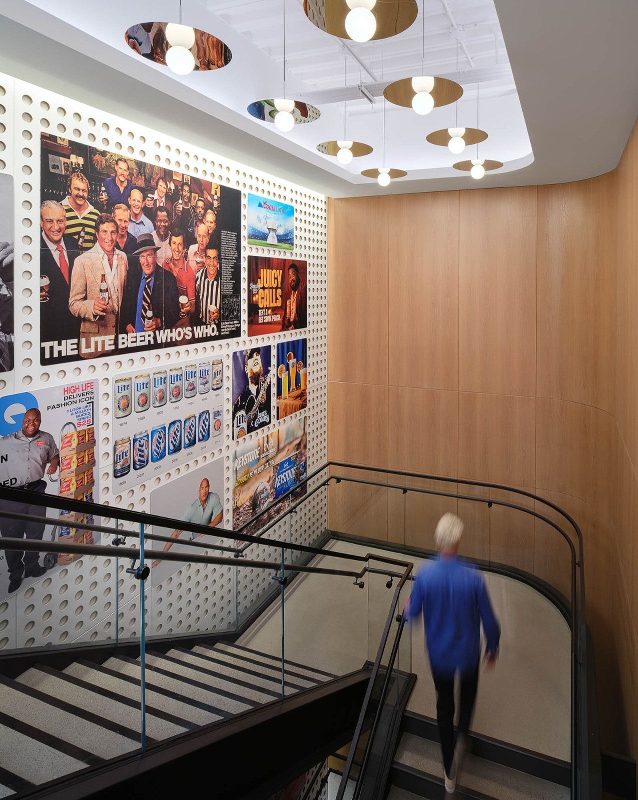 Molson Coors: A stair going down beside a wall of brand photos