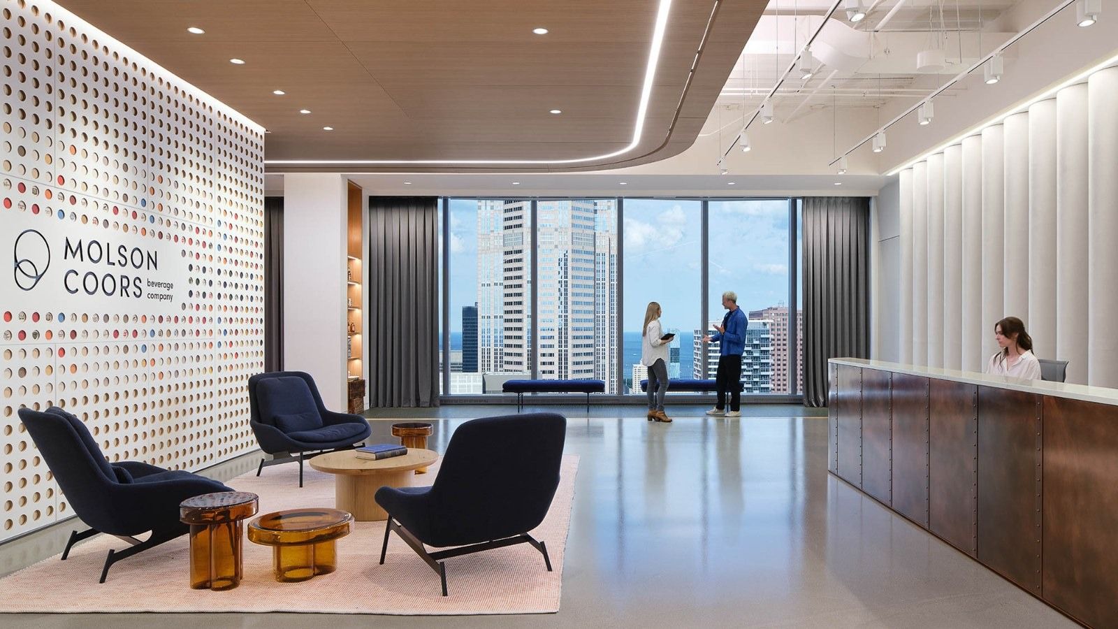 Molson Coors: A white reception with dark armchairs and a wall printed with the Molson Coors name