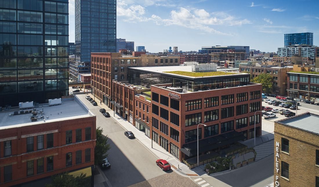 Mondelēz International: Aerial view of brick buildings along a street, with towers of downtown in the background