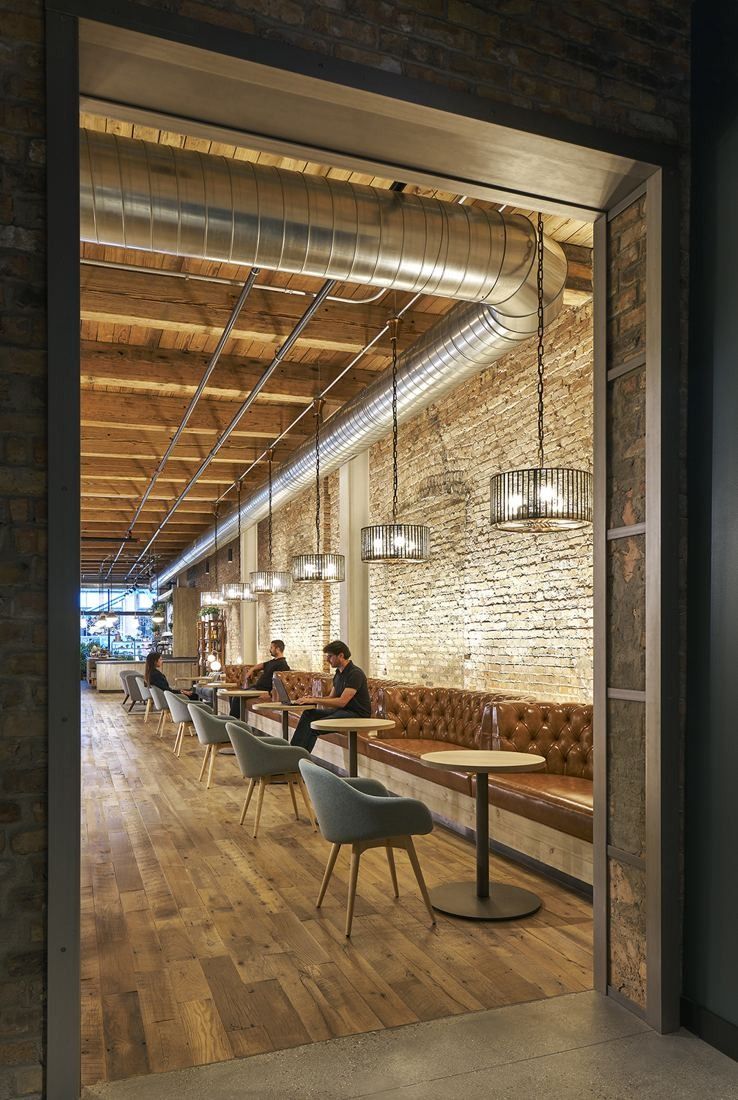 Mondelēz International: View through a dark doorway into a narrow seating area with wooden floors and brick walls