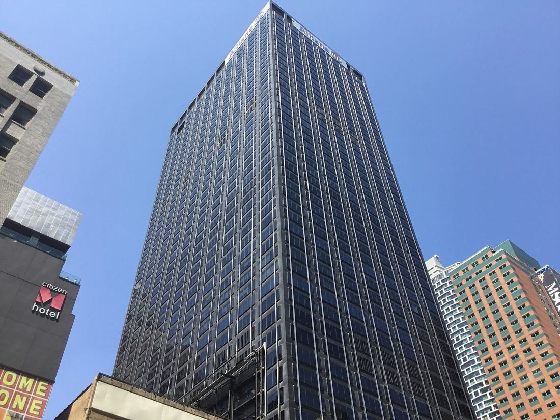 MongoDB: Dark glass-and-steel office tower seen from below against a blue sky
