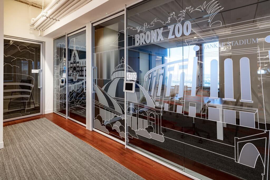 MongoDB: Glass meeting-room walls with large white line drawings of New York landmarks