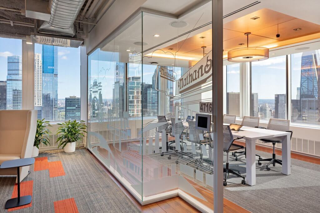 MongoDB: Glass-walled meeting room with a long table and city views through the windows