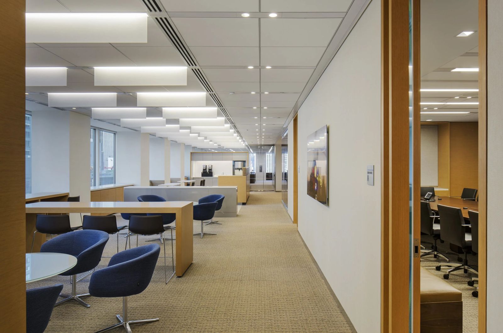 Morgan Stanley: Corridor past a lounge with round blue chairs and open desks