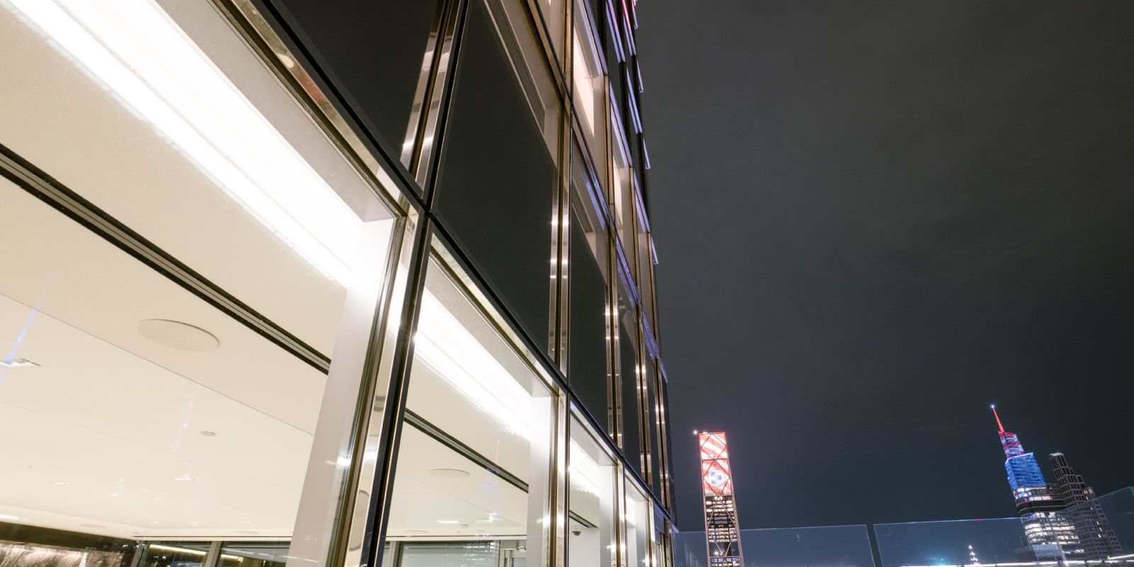 Morgan Stanley: Glass facade with a lit ceiling at night
