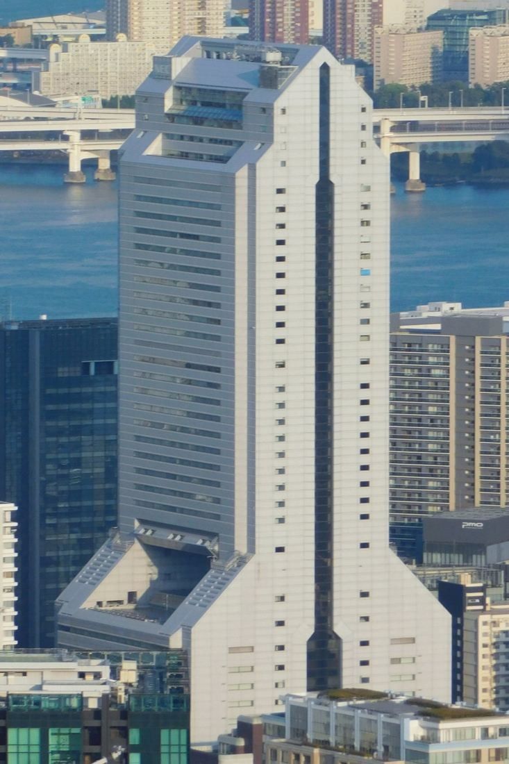 NEC: Stepped tower seen from above with the bay and bridges behind