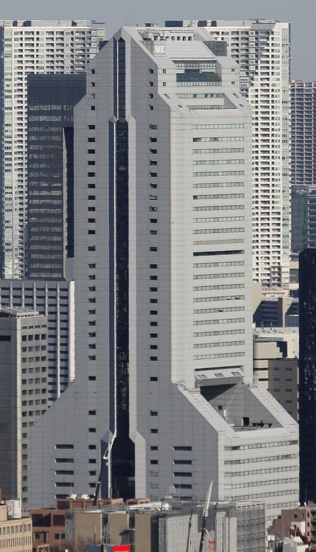 NEC: Stepped tower with a vertical slot down its face among other high-rises