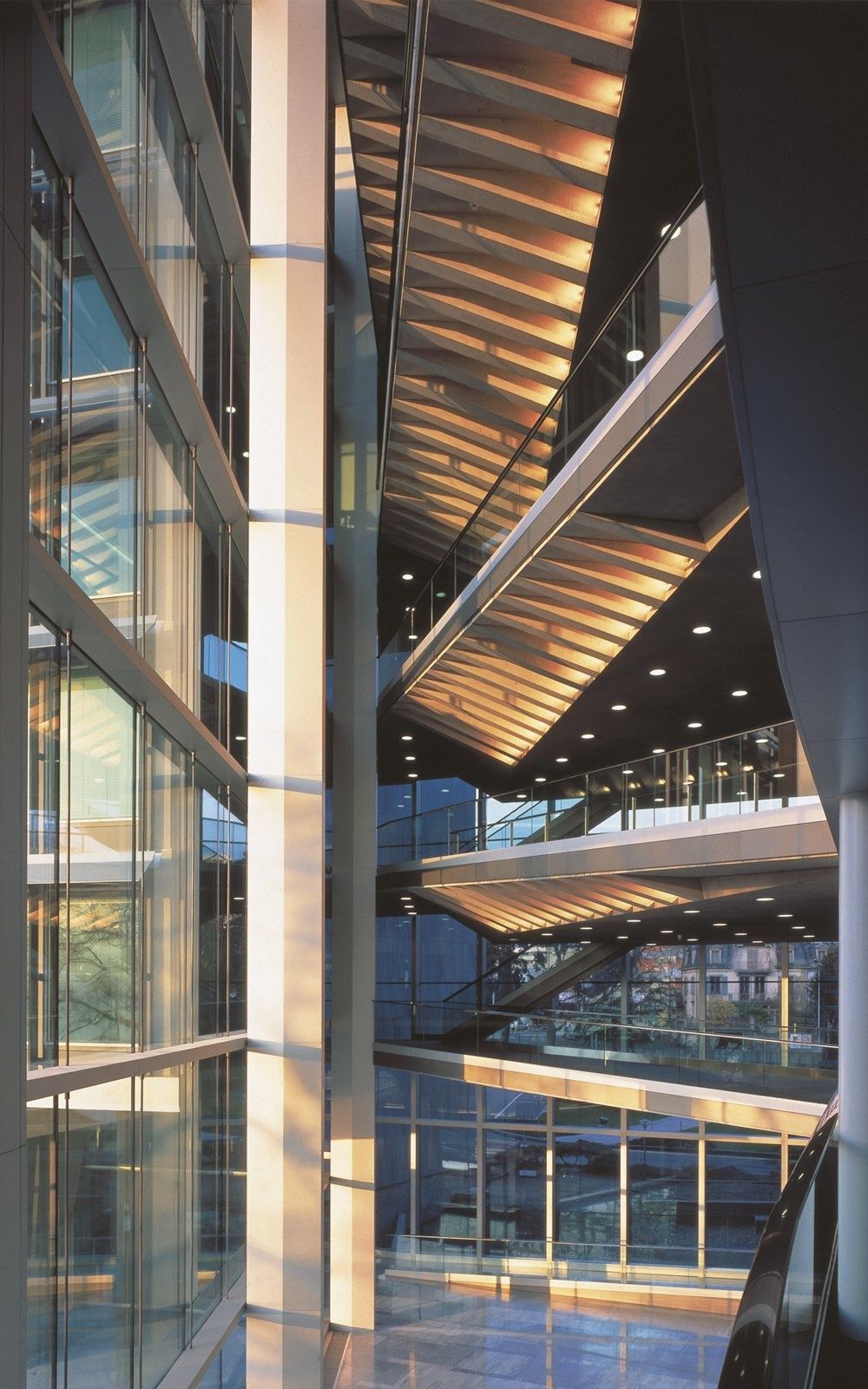 Nestlé: Stacked glass-walled floors lit at dusk