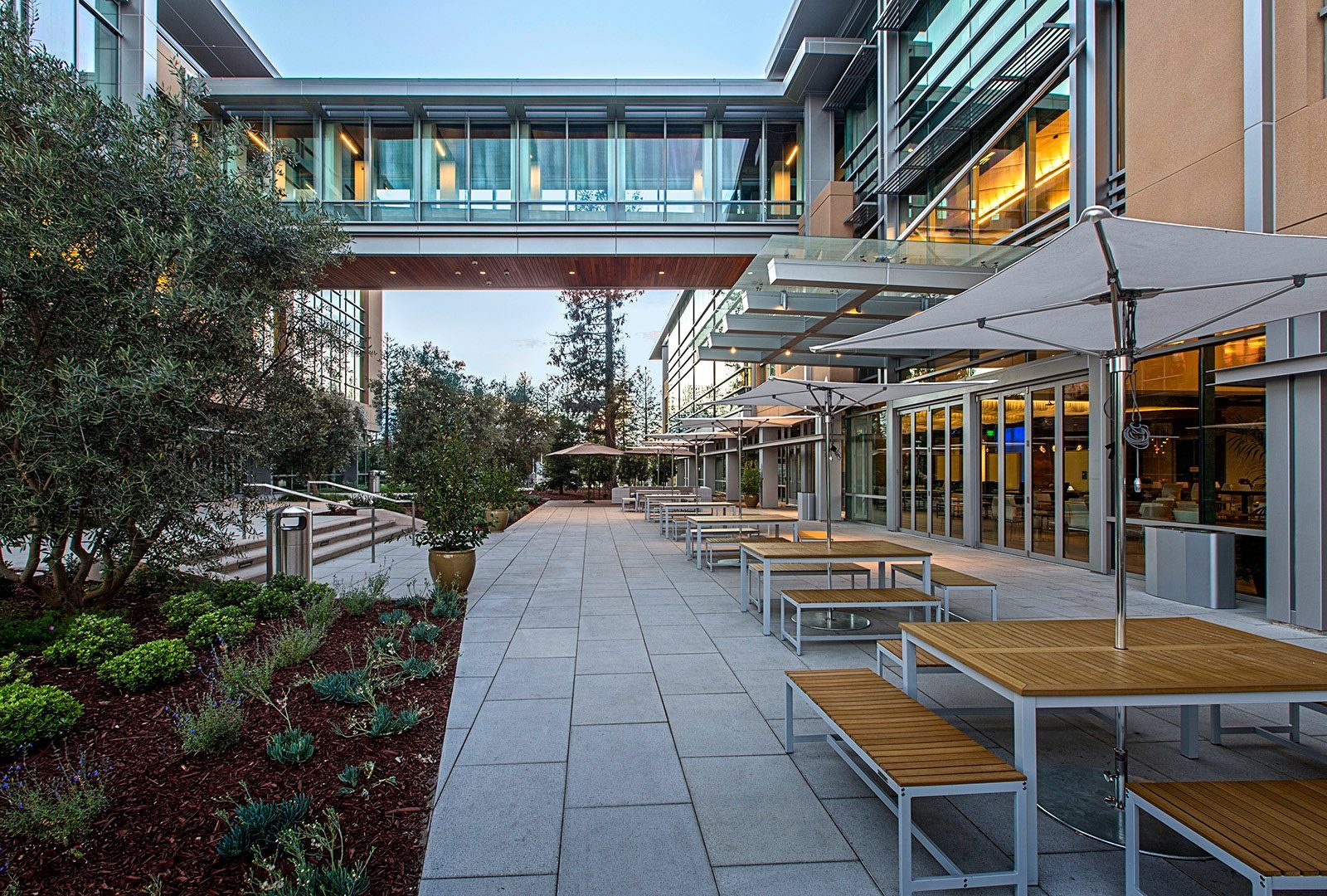 Netflix: Outdoor tables under a bridge between buildings