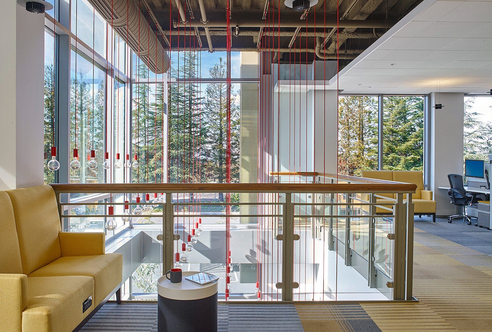 Netflix: Yellow sofa by a glass rail overlooking trees