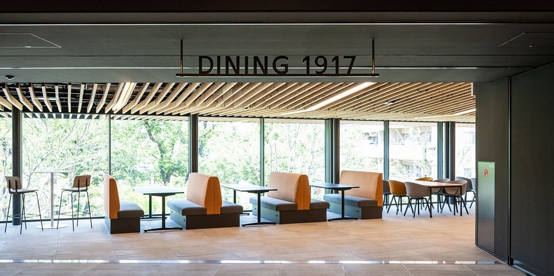 Nikon: Dining area with booth seating along windows onto trees
