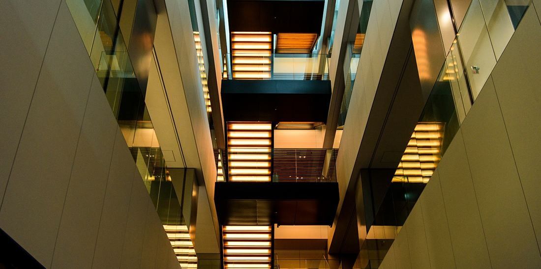 Nikon: Looking up through an open stairwell with lit landings