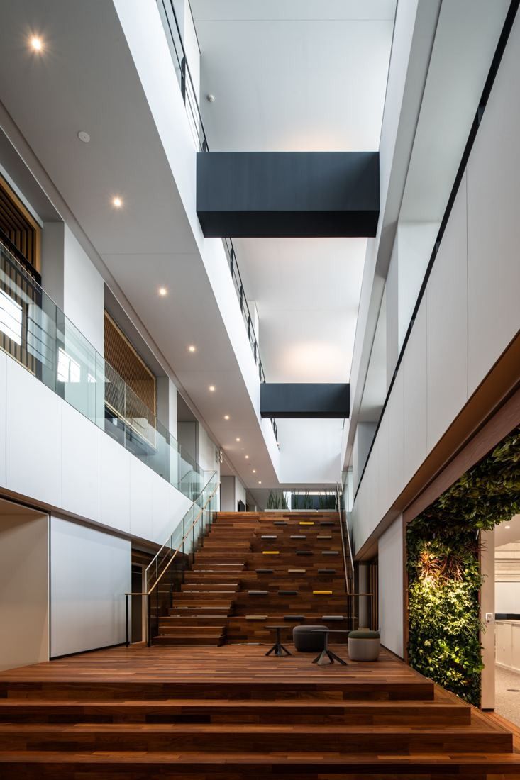Nikon: Narrow vertical space with a wooden stair between white walls
