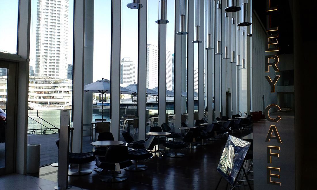 Nissan: Café tables beside floor-to-ceiling windows framed by slender vertical fins