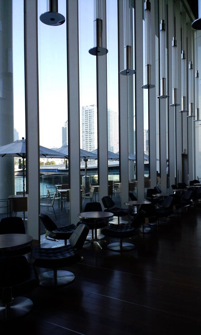 Nissan: Tall window bays lined with slender fins beside café tables