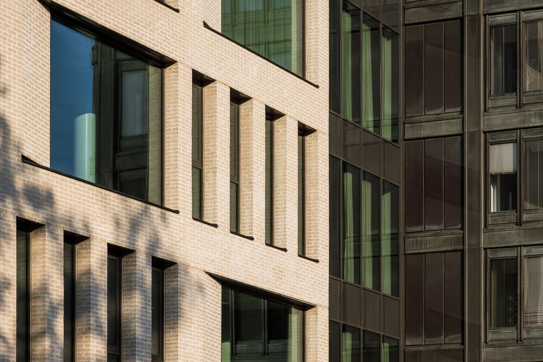 Nordea: Close view of pale brick facade meeting a darker neighbouring facade