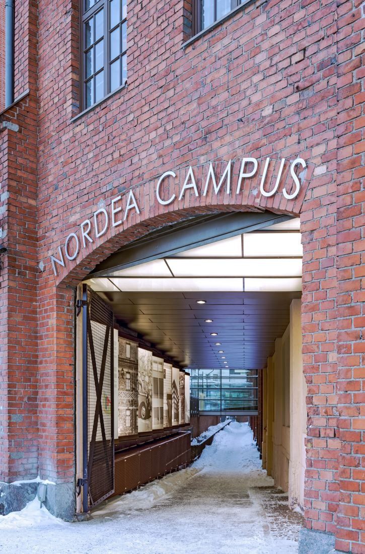 Nordea: Red brick archway with NORDEA CAMPUS lettering leading into a passage