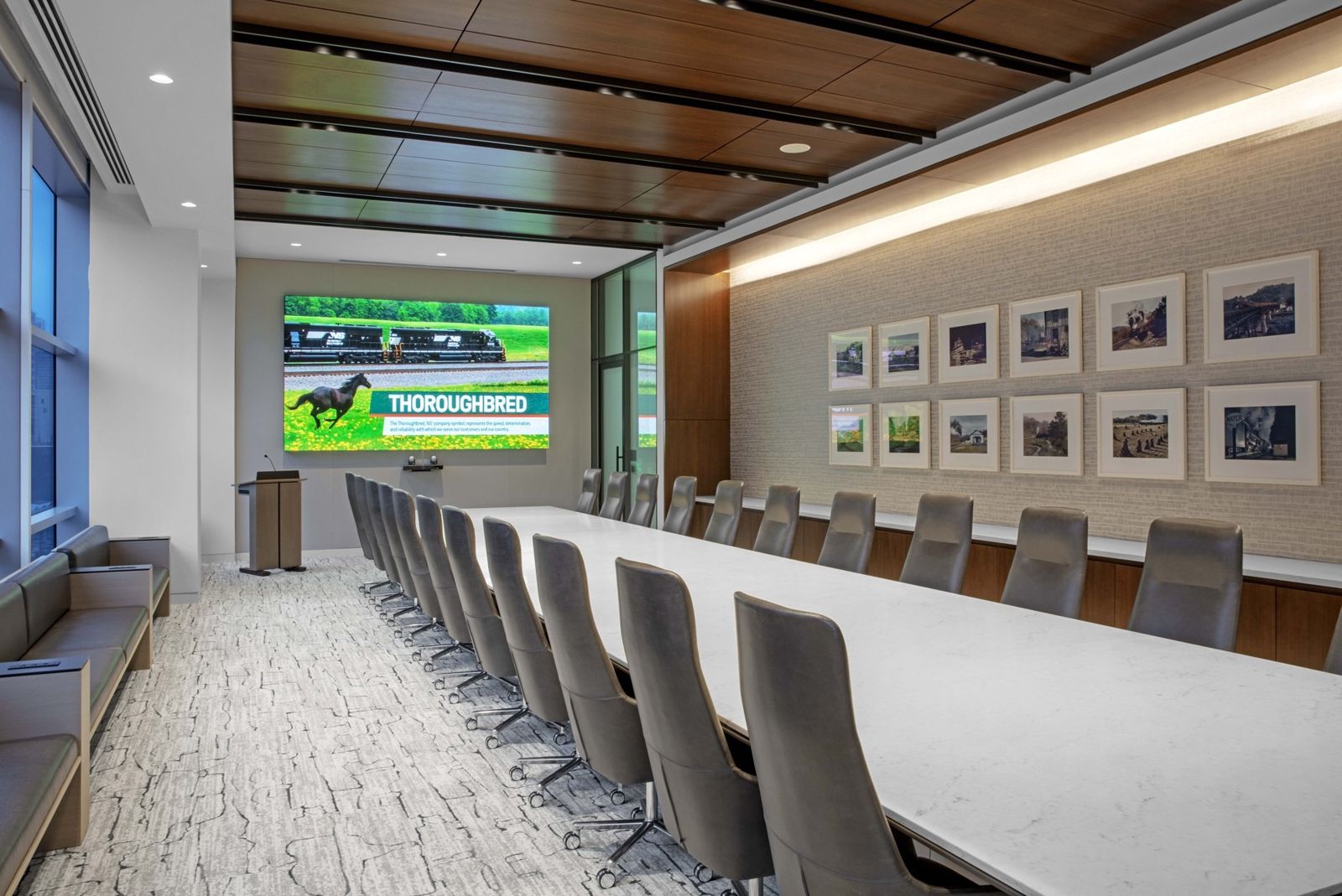 Norfolk Southern: A long boardroom table with a screen and framed photos