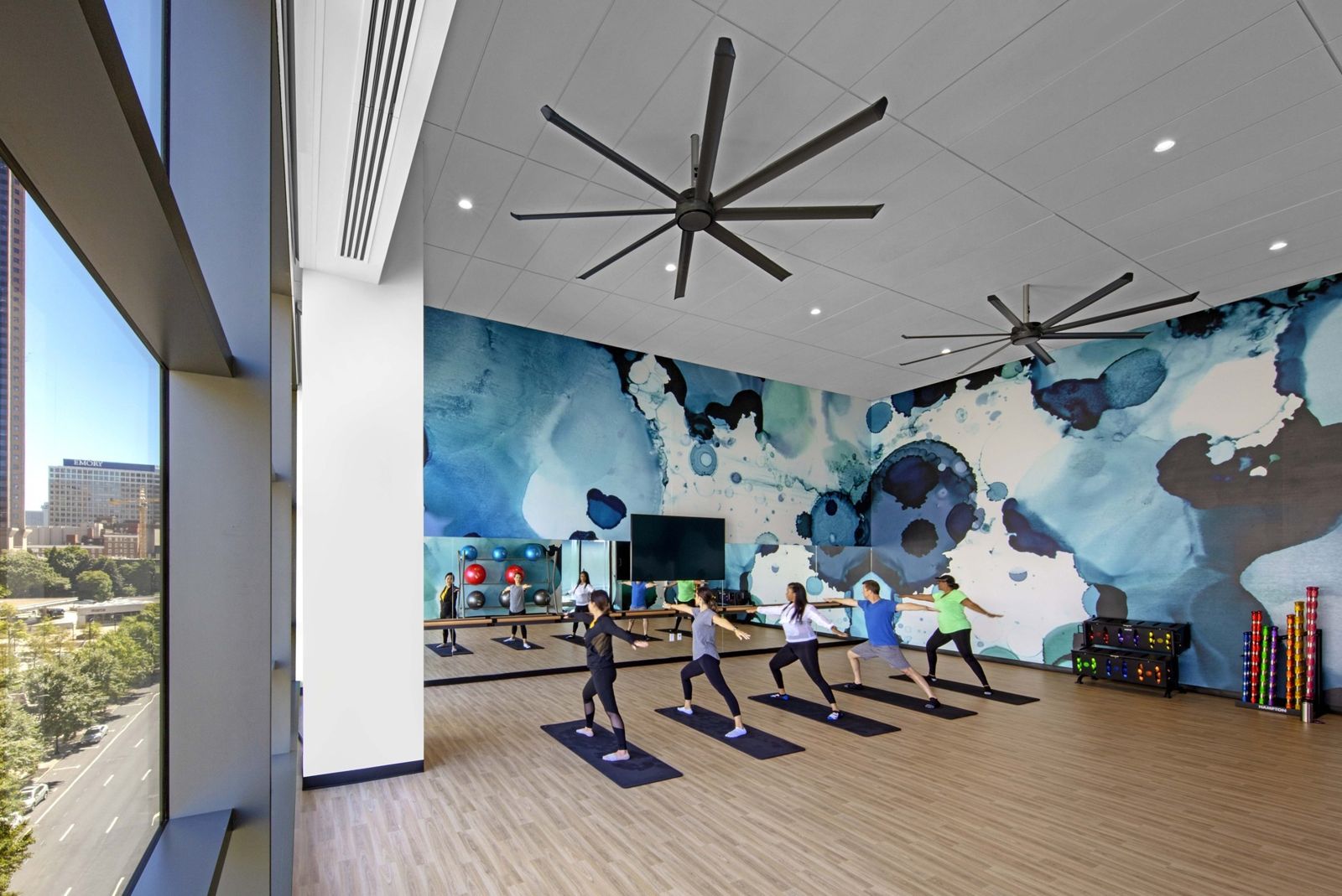 Norfolk Southern: Exercise class in a fitness room with a large mural