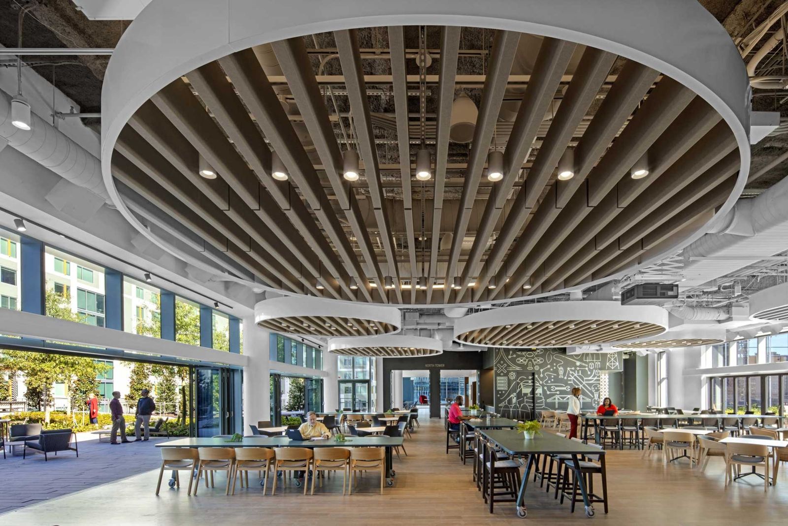 Norfolk Southern: Food hall with long tables under round wooden ceiling rings